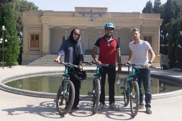 Cyclists are visiting fire temple in Yazd with their bikes.